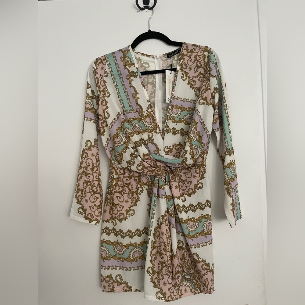 Beautiful printed dress with zip up back. Plunging neckline that is flattering